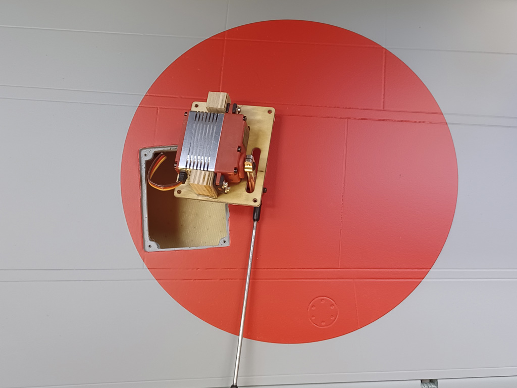 Close up photo of the aileron servo mounted to the hatch on the underside of the TopRC Models 5th scale A6M5 Zero wing panel
