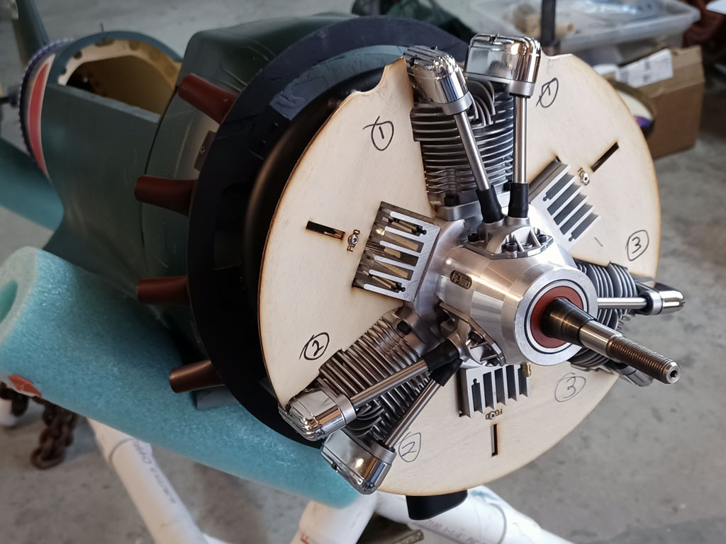 Close up photo of plywood forcing air through the fins of the Saito FG-90R3 radial engine mounted on the TopRC Models 5th scale A6M5 Zero