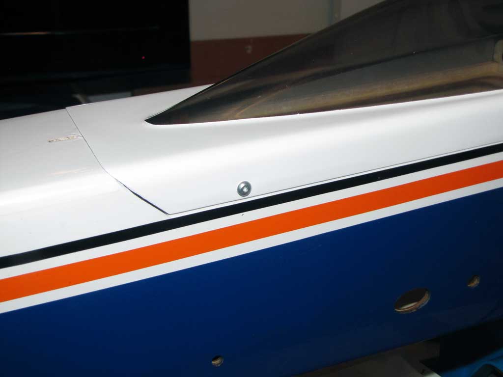 Wide shot of screws used to secure the upper hatch of the Tower Hobbies 62in Kaos model.