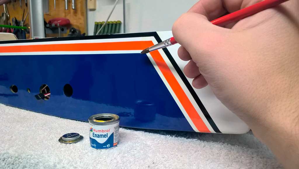 Hand applying a bit of clear enamel to fuel proof the side of a nitro powered Tower Hobbies 62in Kaos where exhaust goo will predictably damage the covering if left exposed.