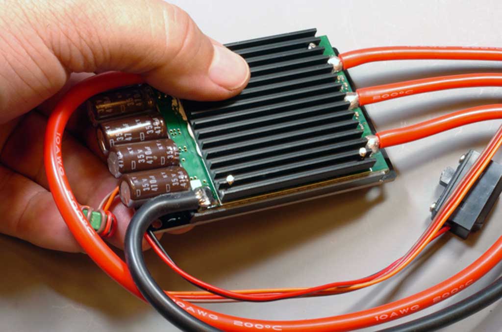 Close up hand holding ProModeler 120A ESC for up to 6S.