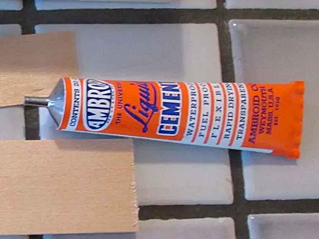 Close up of a tube of Ambroid cement on countertop.