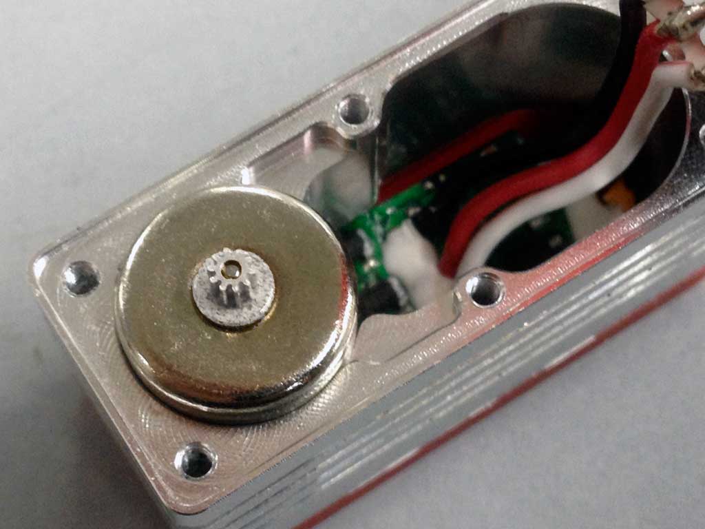 Close up of CL-series ProModeler mini-class servo showing the heat sink center case with full contact motor and cooling fins.