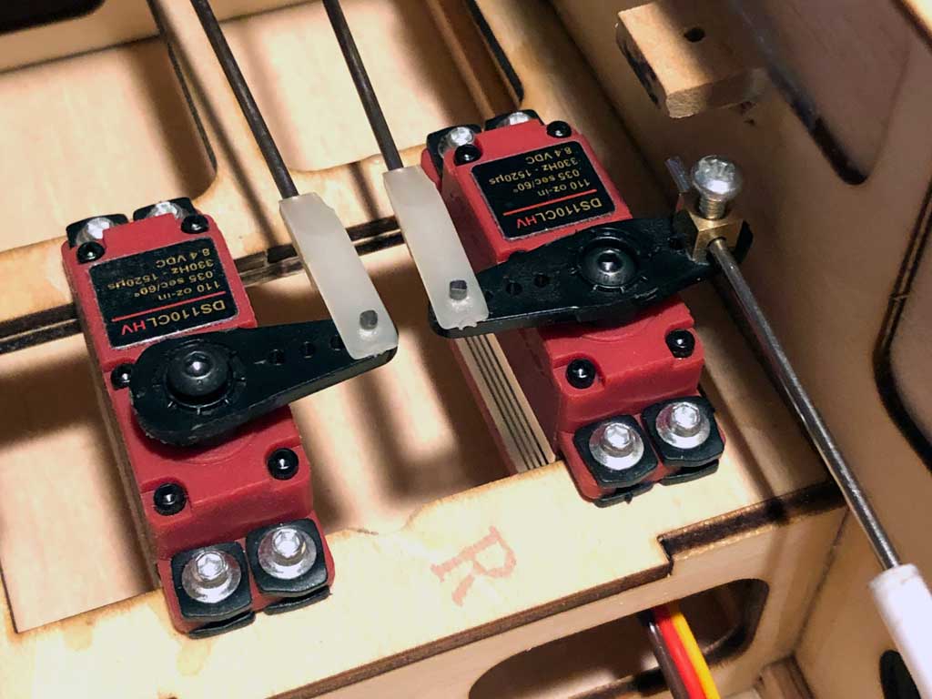 Close up of a pair of ProModeler DS110CLHV mini-class servos within the fuselage of a Tower Hobbies Kaos 60 ARF model.