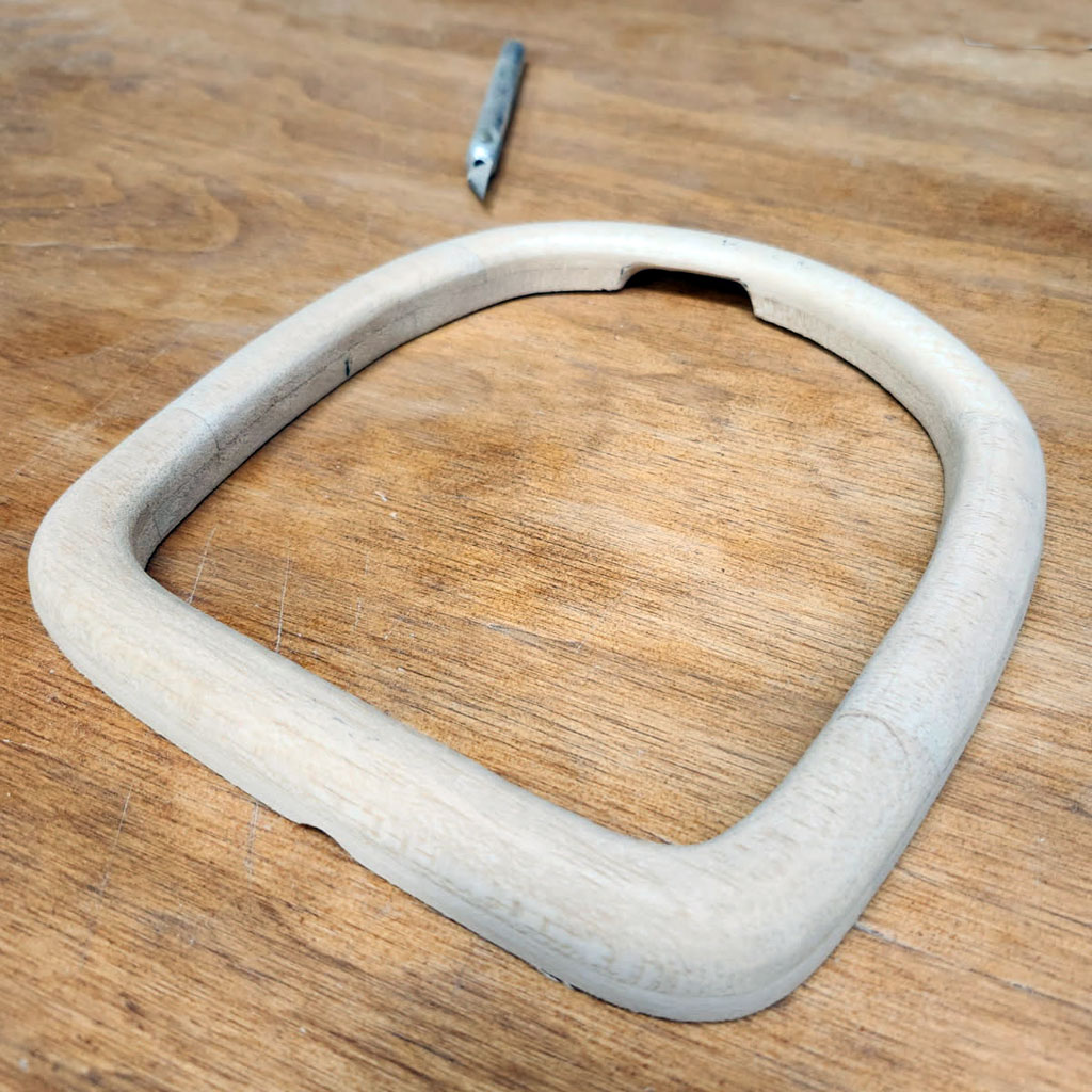 Close up photo of a balsa nose ring created from 1/2-inch balsa stock and sanded to shape