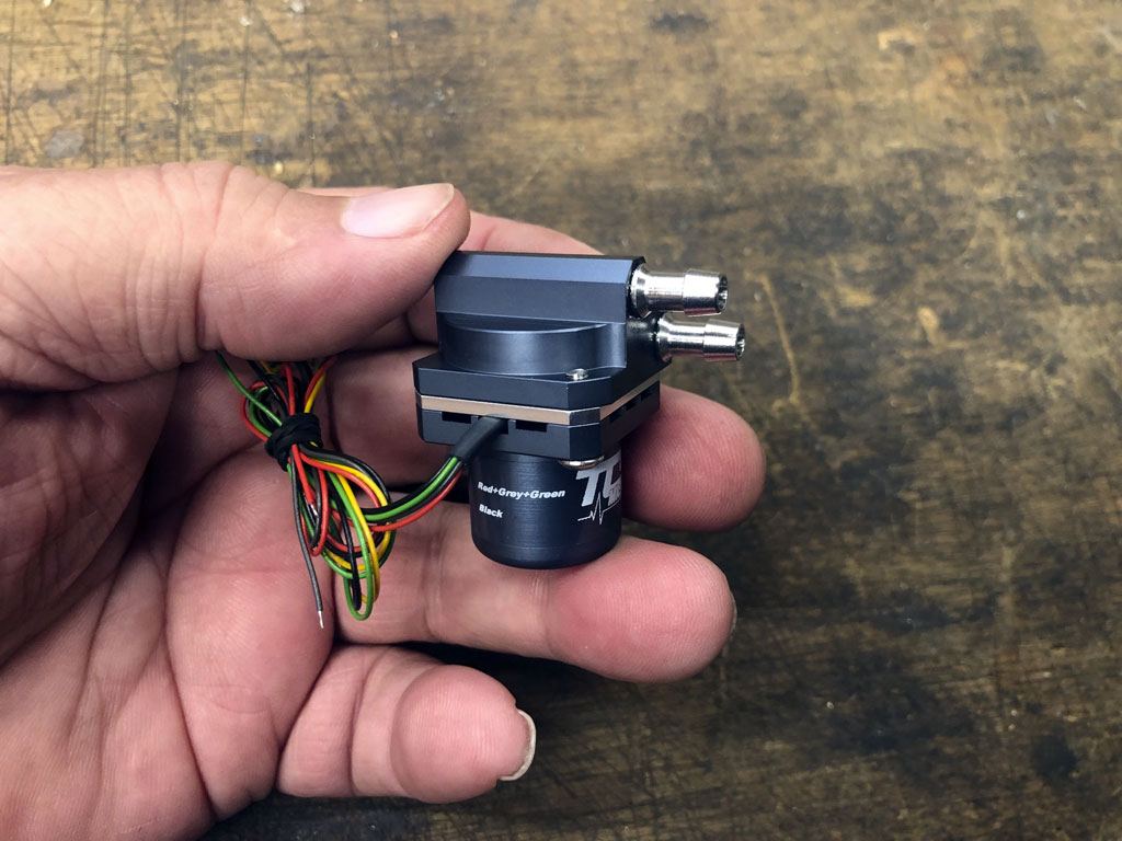 Close up photo of TCS Micropump model M400k v with the 5-wire bundle wrapped neatly