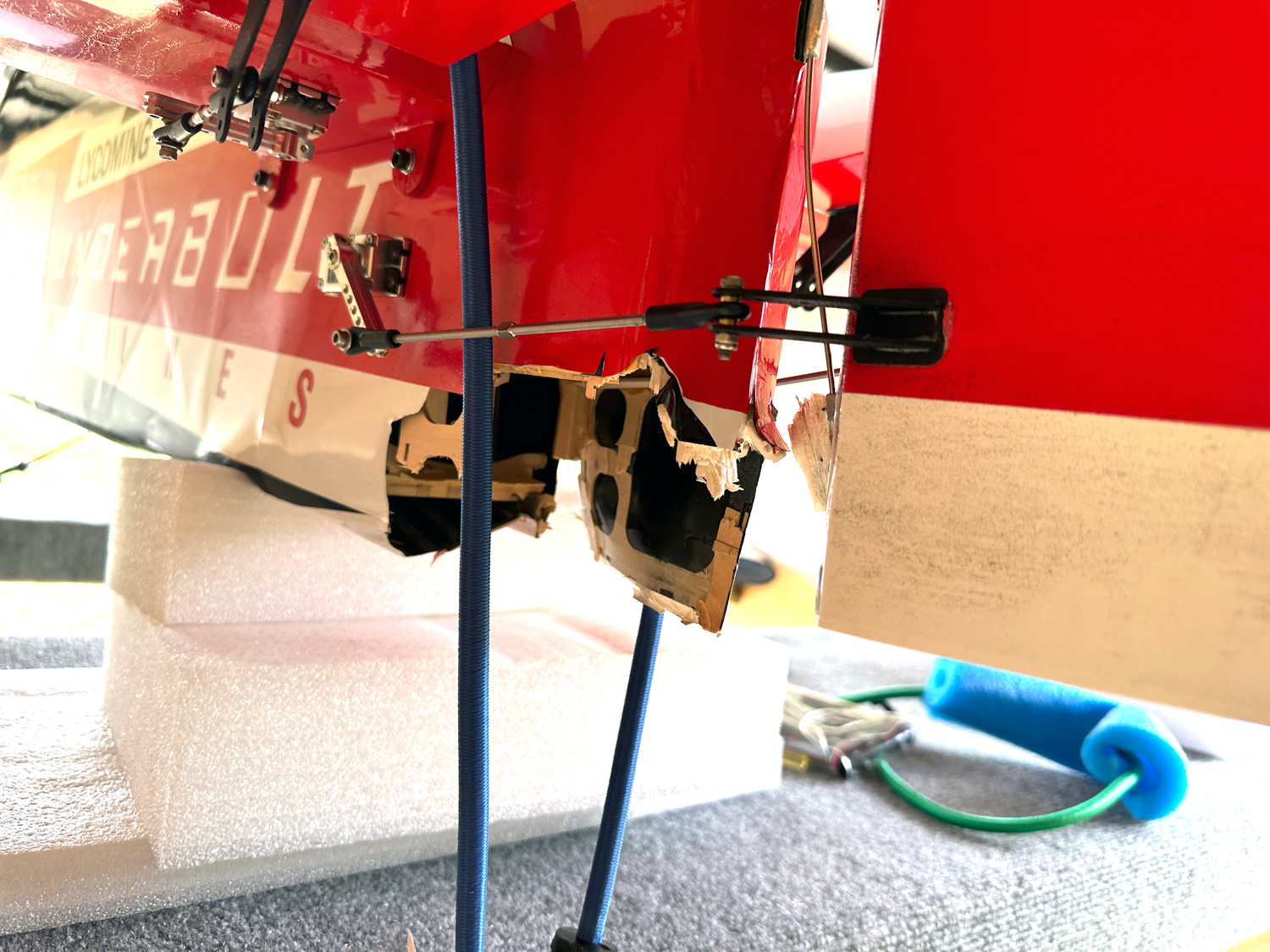 Close up photo showing the heavily damaged aft end of a Pilot RC Sbach 342 with rudder ripped off