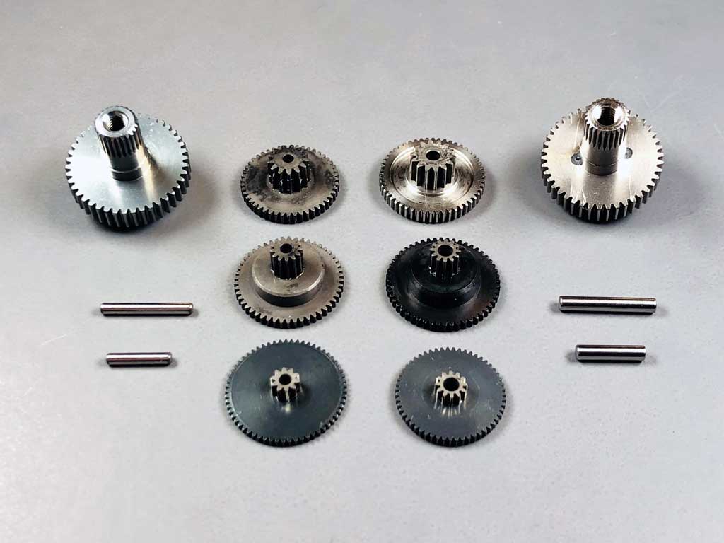 Close up photo showing the gear train of an AccuTORQ 600SG laid out next to a ProModeler DS630BLHV gear train