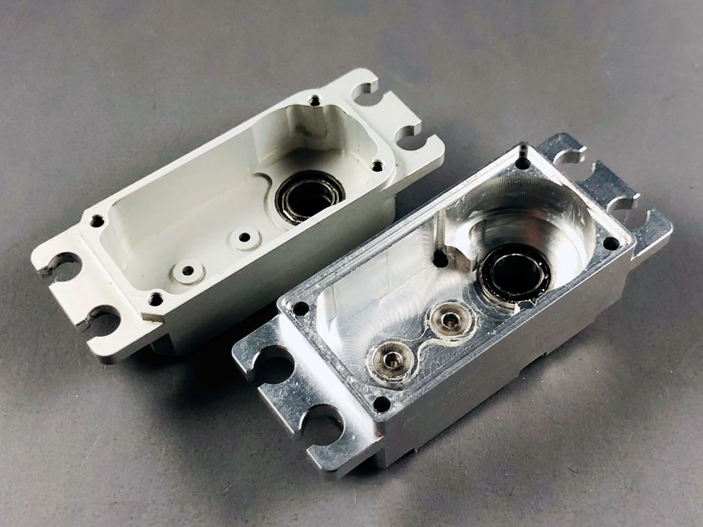Close up of the AccuTORQ 600SG upper case section reveals a reliance on 4-bolts vs 6 for the ProModeler DS630BLHV and critically, the gear shafts are fitted directly to soft aluminum alloy versus bushing reinforcement for the ProModeler 600oz-in brushless servo.