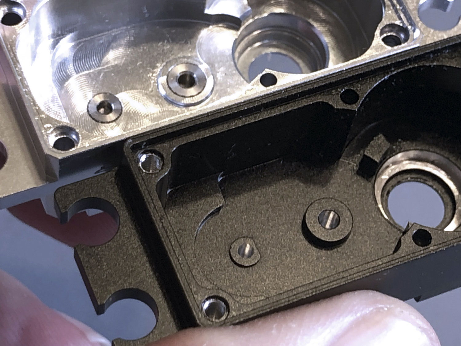 Close up of stainless steel bushings fitted to a ProModeler DS930BLHV servo case as reinforcement versus nothing, just straight aluminum for the shafts fitted to the Futaba HPS-A703 brushless servo