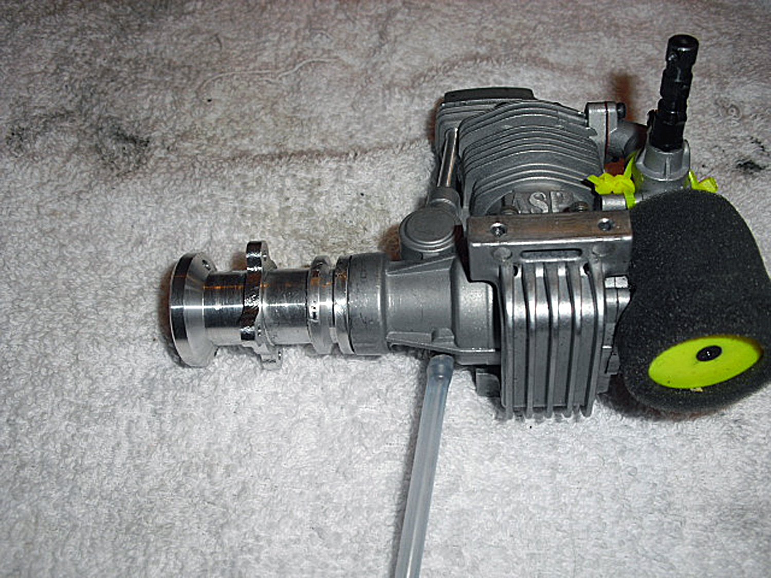 Photo of an ASP91, a clone of an OS MAX FS91, installed within a set of Pantera P6 helicopter mechanics by using an Audacity Models BBC kit plus a fan hub, part number AUD0037