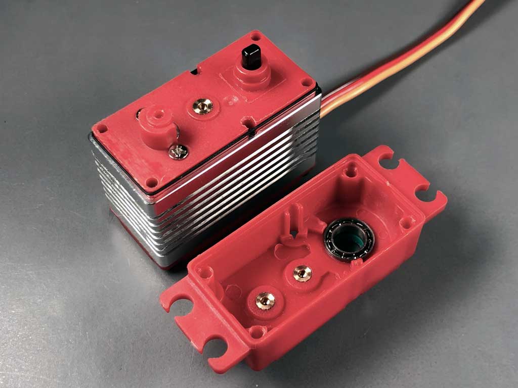 open case of ProModeler servo showing the brass inserts which help keep the geartrain aligned