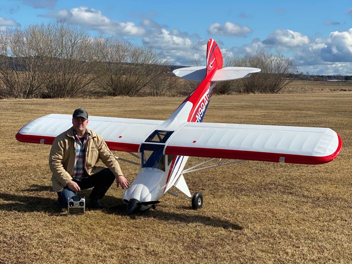 Photo of Maurice Ducharme with his Hangar 9 165-inch Carbon Cub FX-3 in a grassy field